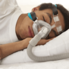 Person using CPAP therapy with a CPAP mask while sleeping