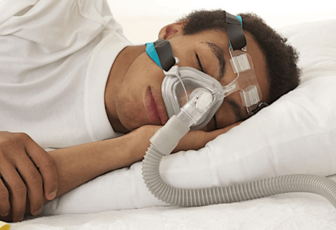 Person using CPAP therapy with a CPAP mask while sleeping